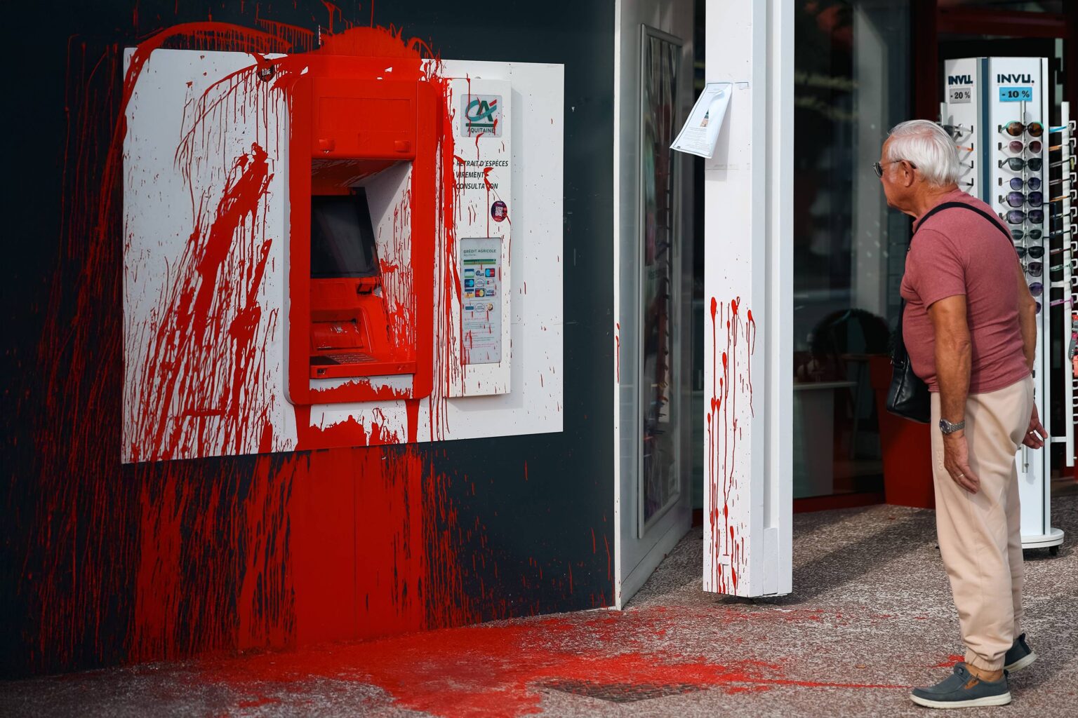 atm-vandalism-red-paint-splattered-elderly-man