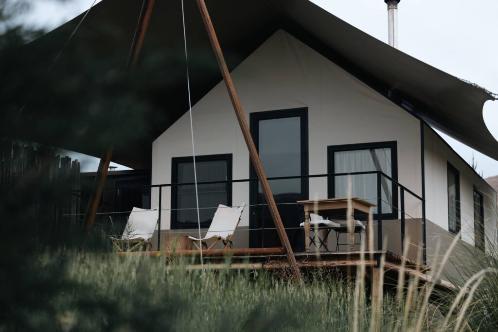 Private glamping terrace with lounge chairs overlooking natural surroundings.